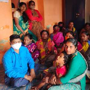 Group of people where 1 men is wearing mask